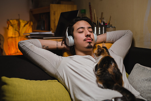 man relaxing while listening to headphones